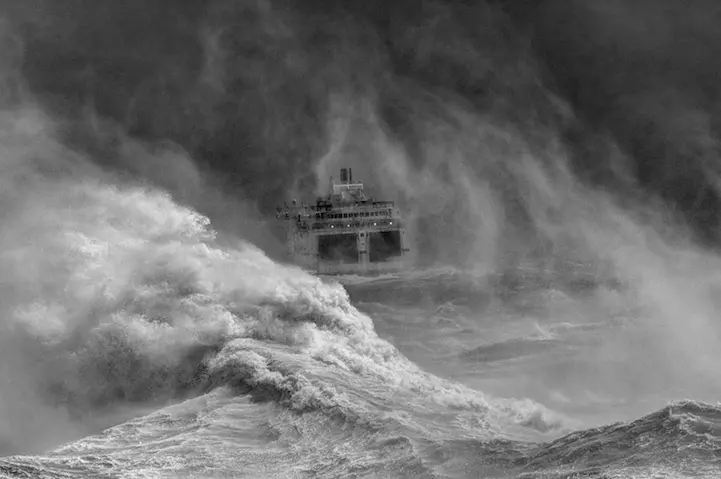 Ferry leaving Newhaven harbour in storm, East Sussex, England
