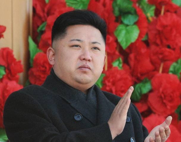 North Korean leader Kim Jong-Un claps his hands during a military parade in Pyongyang