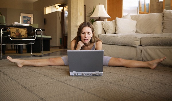 Woman stretching and using laptop