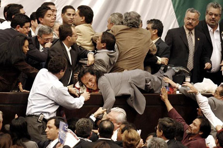 Congressional lawmakers from the PAN pull down a lawmaker of the PRD in Mexico City
