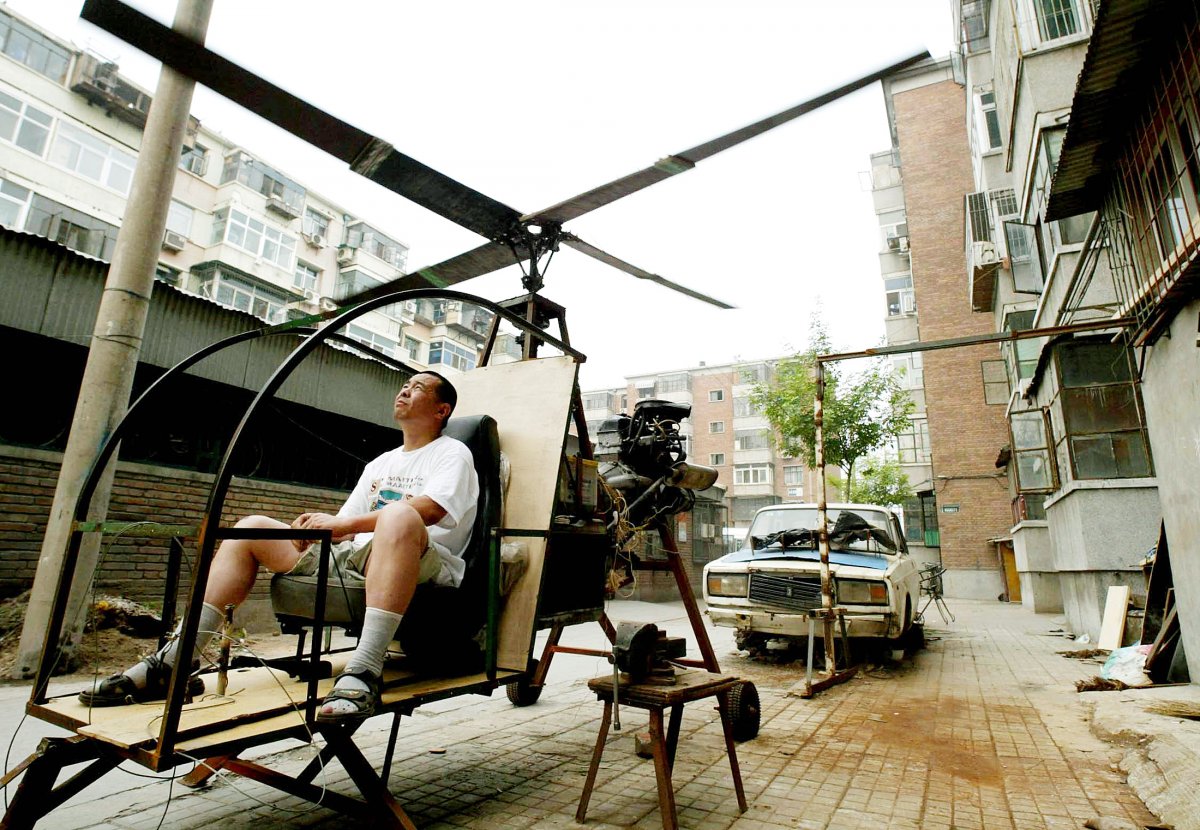 a-self-styled-chinese-inventor-named-yu-jun-tests-his-homemade-helicopter-next-to-his-apartment-in-beijing-june-25-2003