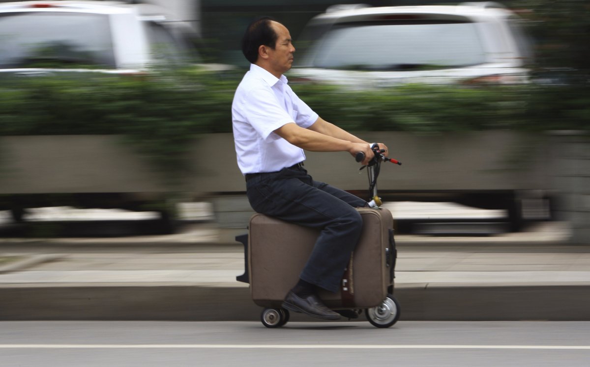he-liang-took-ten-years-modifying-this-suitcase-vehicle-which-has-its-own-motor-and-can-reach-speeds-of-over-12-miles-an-hour-it-can-travel-30-40-miles-on-one-one-charge