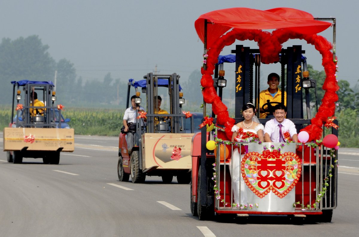 kong-qingyang-and-his-bride-shen-likun-sit-on-a-forklift-turned-wedding-car-in-xingtai-hebei-province-in-china
