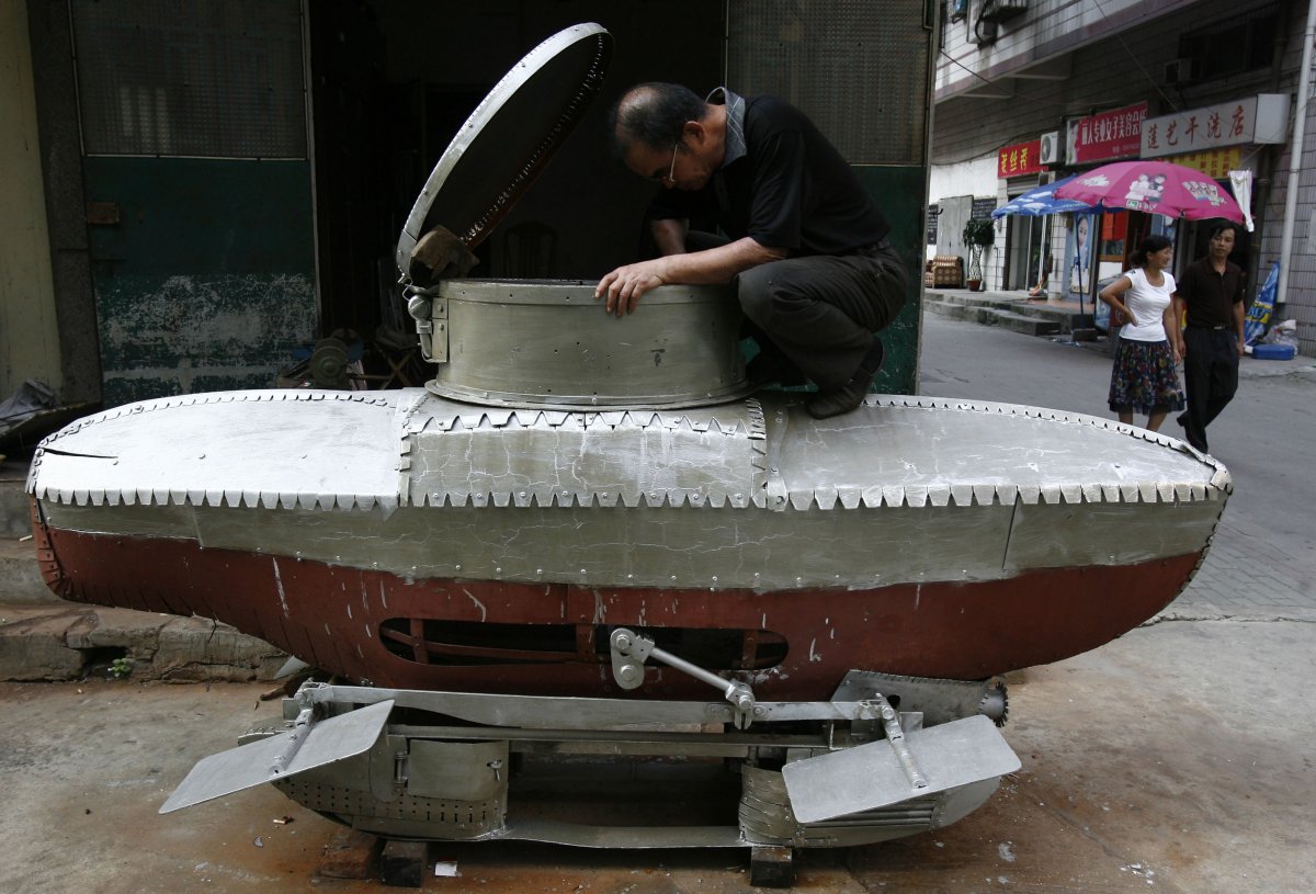 li-yuming-a-local-farmer-who-is-interested-in-scientific-invention-works-on-his-unfinished-miniature-submarine-xiaguang-v-on-the-outskirts-of-wuhan-capital-of-central-chinas-hubei-province