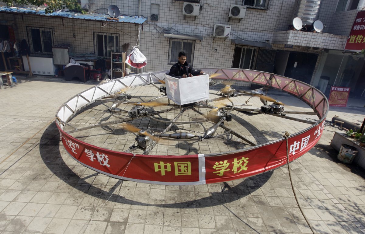 local-farmer-shu-mansheng-hovers-above-the-ground-in-his-self-designed-and-homemade-flying-device-during-a-test-flight-in-front-of-his-house-in-dashu-village-on-the-outskirts-of-wuhan-hubei-province