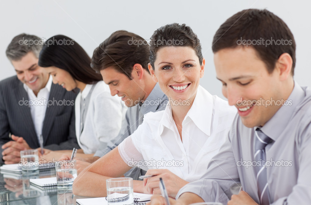 International business people taking notes in a meeting
