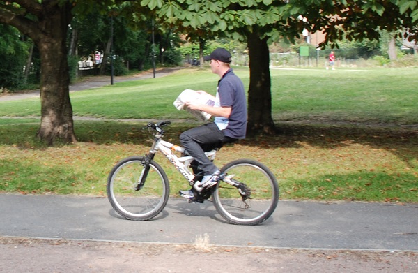 Riding-a-bike-while-reading-a-paper