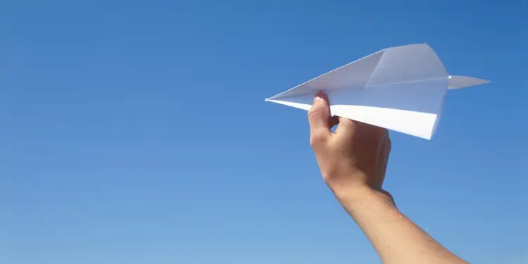 Hand with paper plane