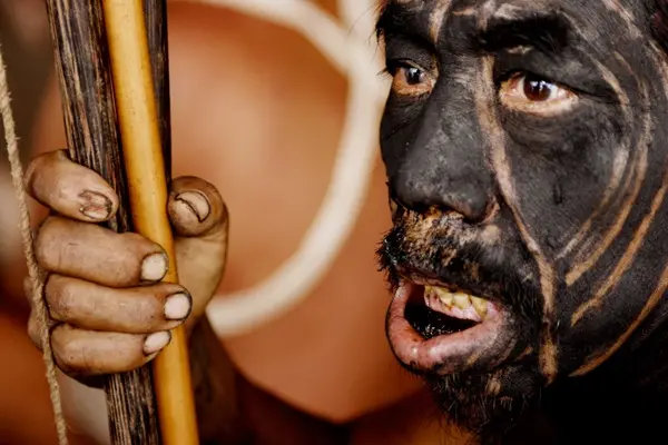 Yanomami shaman watching a tribal dance.
