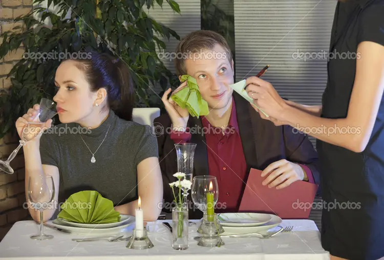waitress writing a order from couple in a restaurant