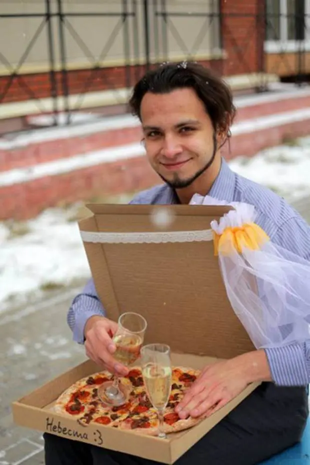 Pic shows: 22-year-old Russian marries a pizza.nnA lonely Russian gourmet fed up of not having a better half has married a pizza.nnThe bizarre wedding ceremony took place in a pizzeria in the city of Tomsk, in the Tomsk Oblast region that is located in south-central Russia.nnThe man who was not named said he came up with the idea because she was fed up of being alone.nnHe said: "At some point I realized that half of my friends are complaining about their better half, while the others were complaining about the lack of a better half."nn"Love between two humans is a complicated wild thing. I was grateful that I had at least my love of food and then it came to me that actually love for food remains stable no matter what."nn"Pizza would not reject you or betray you, and speaking quite frankly and sincerely, I love it."nnSceptical Russian authorities refused to give official permission to register the unusual marriage at a registry office, and the church also turned him down.nnSo in the end the unusual ceremony went ahead in one of the city¿s pizzerias. Managers and cooks at the restaurant even went as far as to provide the man with a certificate of marriage, and the pizza bride was covered in a bridal veil.nnAfter that the happy groom posed in front of many cameras with his "wife". Details of what they did on their honeymoon night together were not revealed.nn(ends)