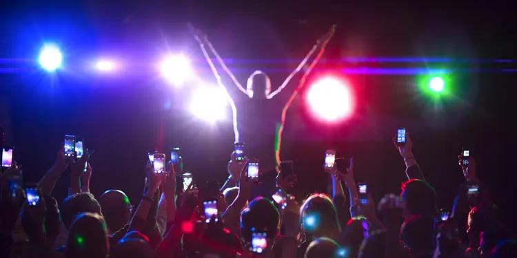 Audience photographing musician on stage