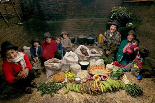 ECU04.0001.xxf1rw (MODEL RELEASED IMAGE) The Ayme family in their kitchen house in Tingo, Ecuador, a village in the central Andes, with one week’s worth of food. Ermelinda Ayme Sichigalo, 37, and Orlando Ayme, 35, sit flanked by their children (left to right): Livia, 15, Natalie, 8, Moises, 11, Alvarito, 4, Jessica, 10, Orlando hijo (Junior, held by Ermelinda), 9 months, and Mauricio, 30 months. Not in photograph: Lucia, 5, who lives with her grandparents to help them out. Cooking method: wood fire. Food preservation: natural drying. /// The Ayme family is one of the thirty families featured in the book Hungry Planet: What the World Eats (p. 106). Food expenditure for one week: $31.55 USD. (Please refer to Hungry Planet book p. 107 for the family’s detailed food list.)