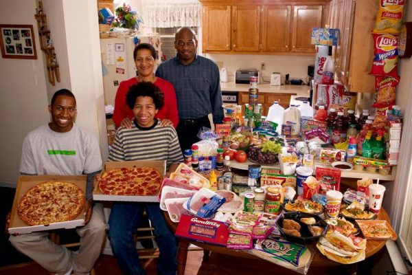 USnc04.0001.xxf1rw (MODEL RELEASED IMAGE) The Revis family in the kitchen of their home in suburban Raleigh, North Carolina, with a week’s worth of food. Ronald Revis, 39, and Rosemary Revis, 40, stand behind Rosemary’s sons from her first marriage, Brandon Demery, 16 (left), and Tyrone Demery, 14. Cooking methods: electric stove, toaster oven, microwave, outdoor BBQ. Food preservation: refrigerator-freezer. Favorite foods—Ronald and Brandon: spaghetti. Rosemary: “potatoes of any kind.” Tyrone: sesame chicken. /// The Revis family is one of the thirty families featured in the book Hungry Planet: What the World Eats (p. 266). Food expenditure for one week: $341.98 USD. (Please refer to Hungry Planet book p. 267 for the family’s detailed food list.)