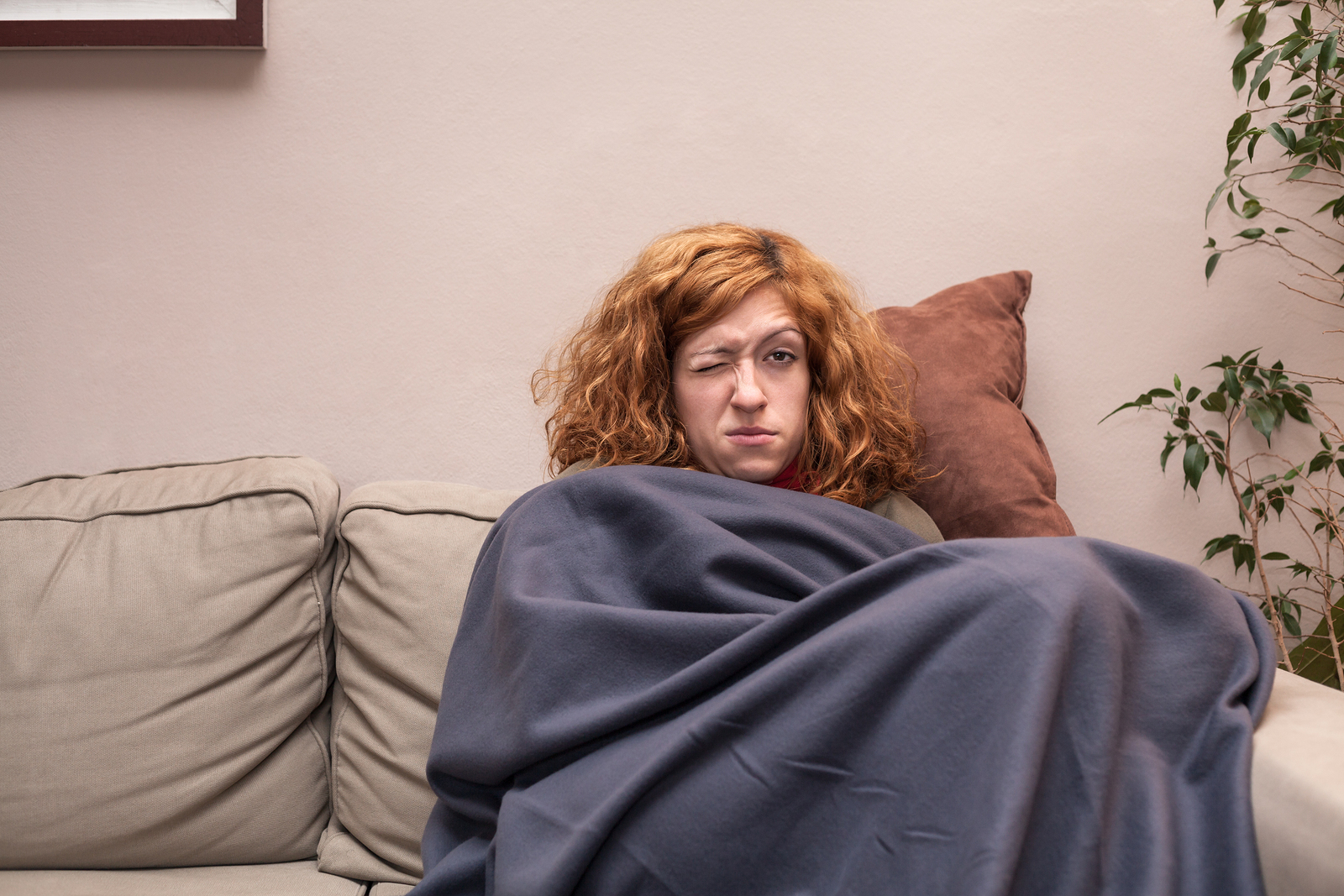 Tired Woman With A Cold Resting On Sofa
