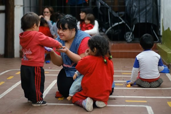 Noelia Garella (C), a kindergarten teacher born with Down Syndrome, plays with children at the Jeromito kindergarten in Cordoba, Argentina on September 29, 2016. When Noelia Garella was a child, a nursery school rejected her as a "monster." Now 31, she is in a class of her own. In the face of prejudice, she is the first person with Down syndrome to work as a kindergarten teacher in Argentina -- and one of few in the world. / AFP / DIEGO LIMA (Photo credit should read DIEGO LIMA/AFP/Getty Images)