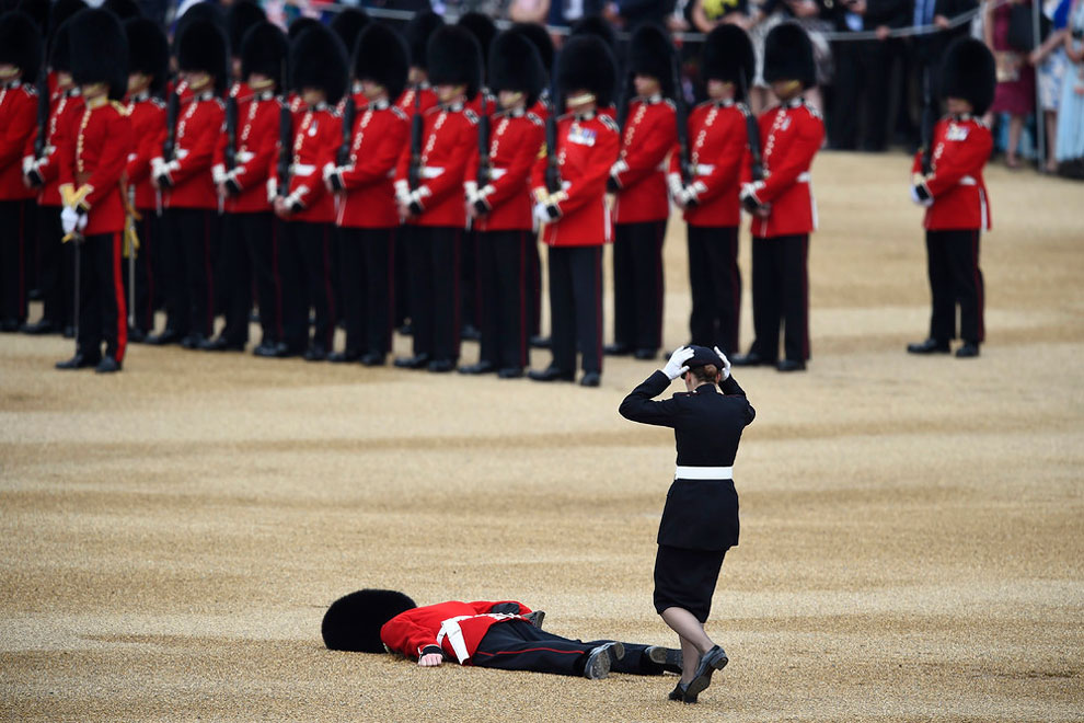 A Guardsman faints at Horseguards Parade for the annual Trooping the Colour ceremony in central London, Britain June 11, 2016.