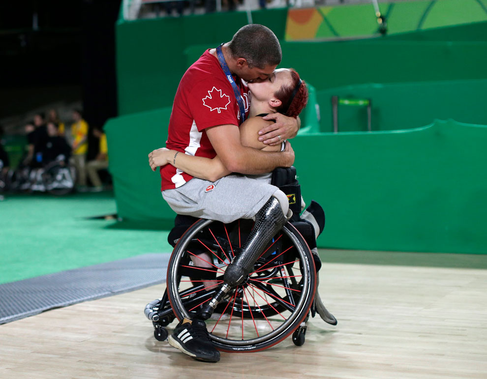 Adam Lancia embraces his wife Jamey Jewells of Canada after her women’s wheelchair basketball playoff match against China at the Rio Paralympics September 16, 2016.