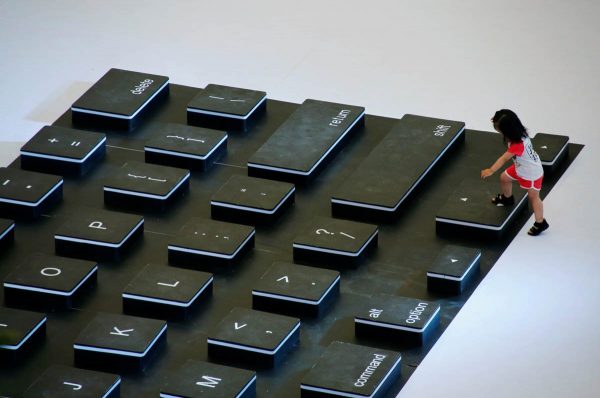 a-child-climbs-onto-a-giant-laptop-keyboard-during-a-promotion-event-at-a-shopping-centre-in-beijing-china
