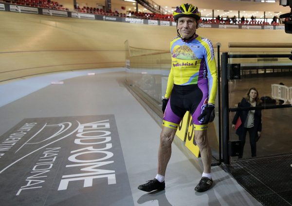 French cyclist Robert Marchand, aged 102, walks onto the track at the indoor Velodrome National in Montigny-les-Bretonneux