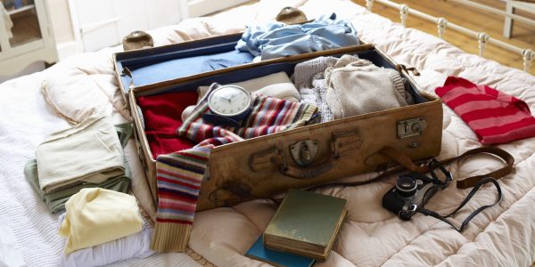 Items in suitcase on bed.