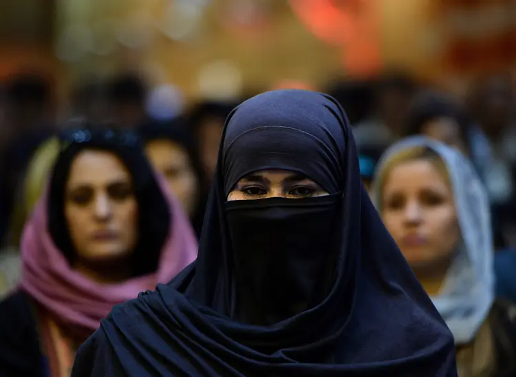 Afghan women attend a political gathering in a wedding hall in Kabul on September 3, 2013. Opposition leader Abdullah Abdullah speaking to around a 1000 of his supporters in wedding hall before the landmark 2014 elections. AFP PHOTO/ SHAH Marai (Photo credit should read SHAH MARAI/AFP/Getty Images)