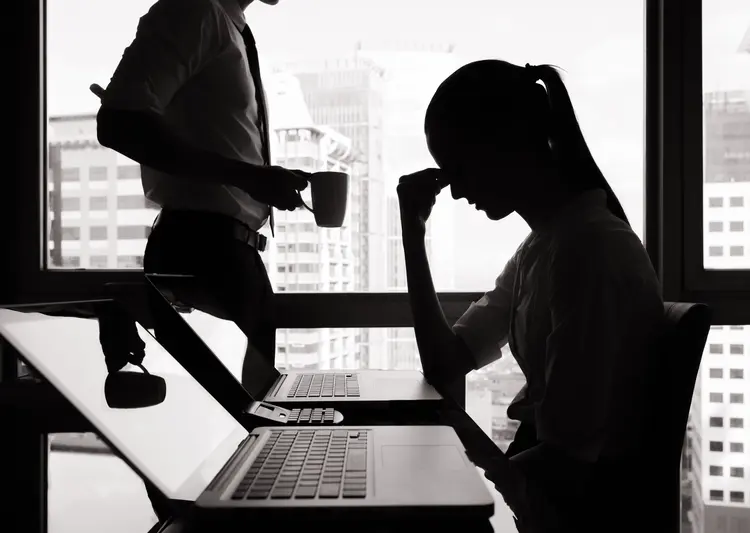 Silhouettes of stressed business woman in the office.